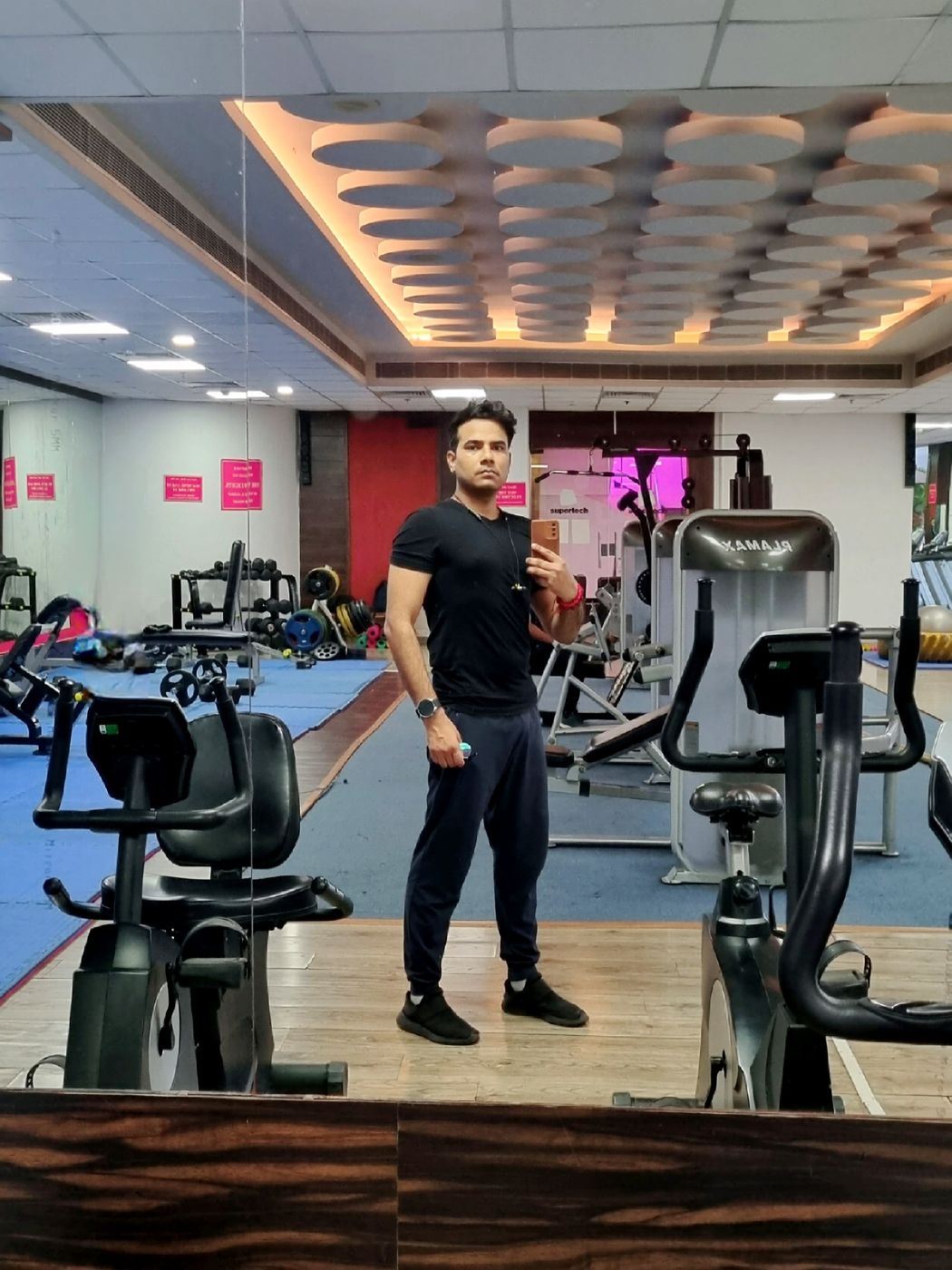 Diwakar taking a mirror photo at the gym